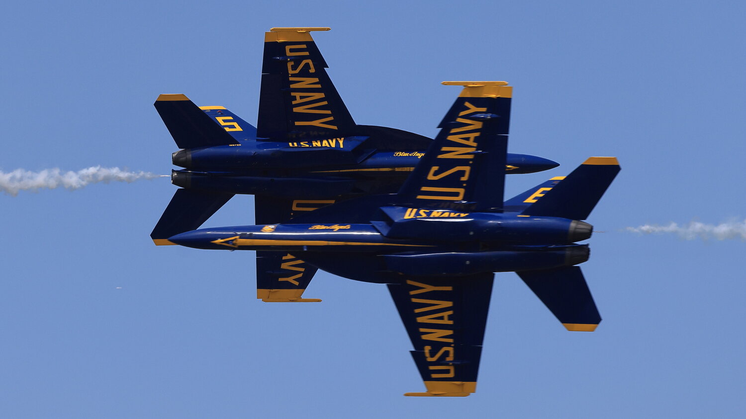 The opposing passes of the Blue Angels are spectacular to watch as they approach the crossing point at over 450 miles per hour from opposite directions. Even at a camera shutter speed of one-4,000th of a second, one of the jets has just a touch of blur...